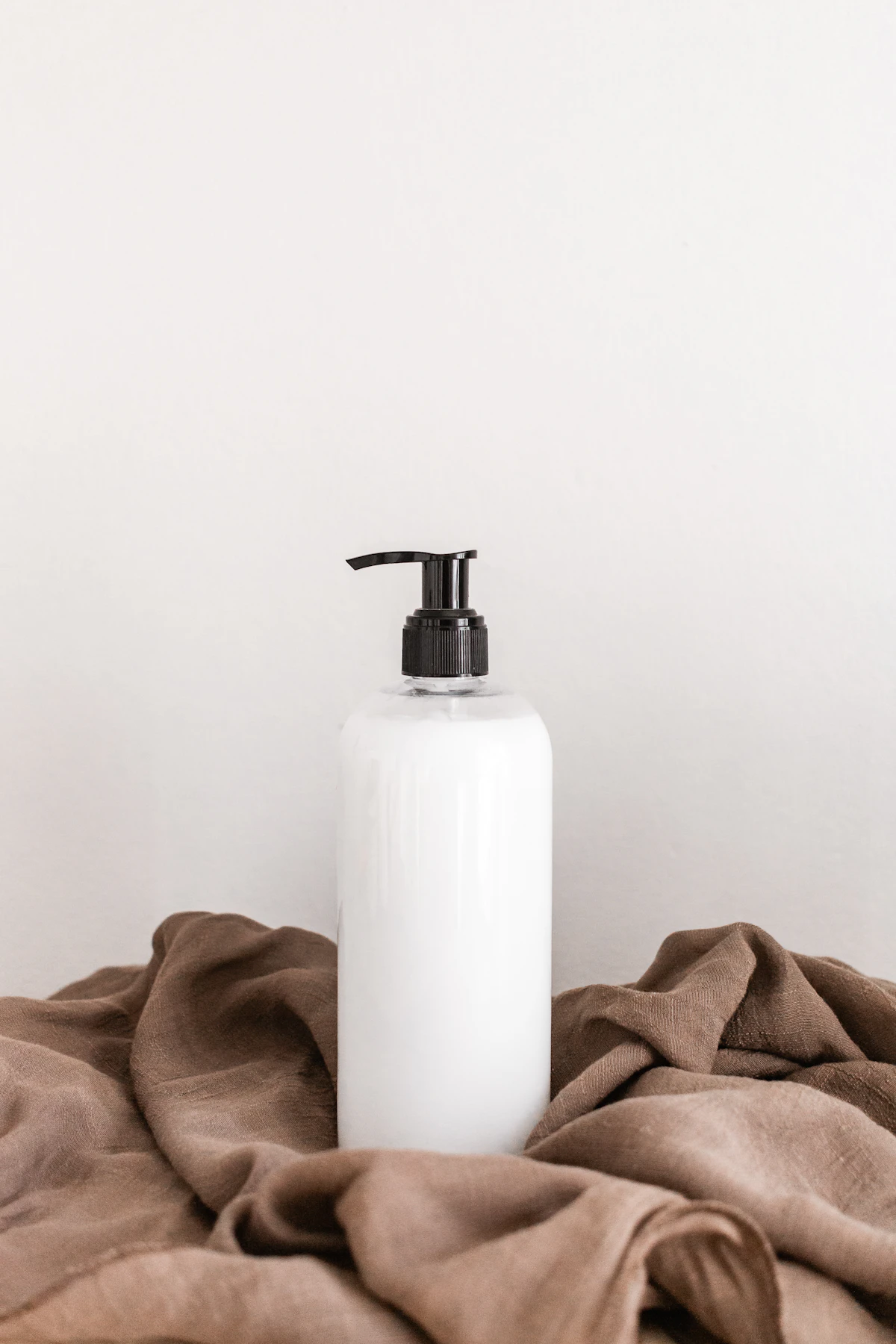 Soft Water Essence bottle with a fine mist of droplets